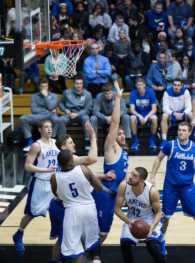 GVL / Kevin Sielaff - Ricardo Carbajal (32) posts up beneath the basket.  The Lakers defeat the Chargers of Hillsdale College Saturday, Jan. 30, 2016 in Allendale.