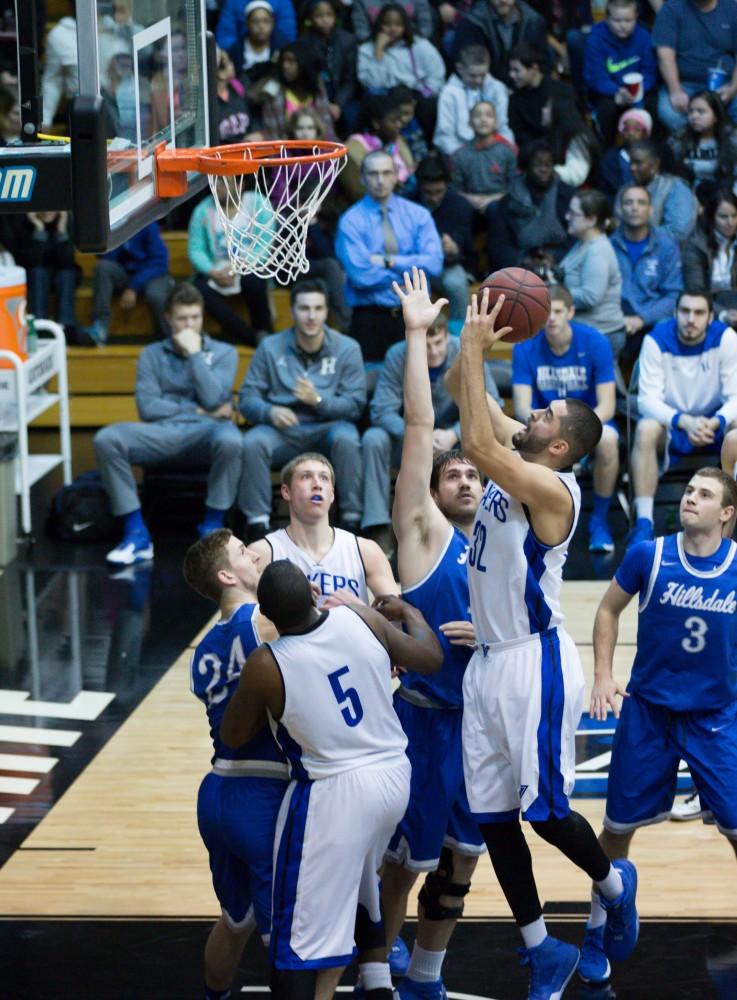 GVL / Kevin Sielaff - Ricardo Carbajal (32) pulls up for a shot in the paint.  The Lakers defeat the Chargers of Hillsdale College Saturday, Jan. 30, 2016 in Allendale.