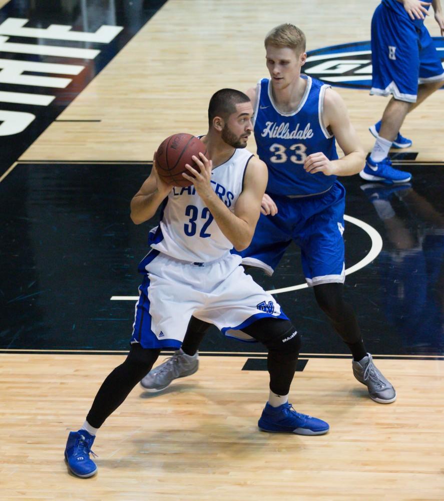 GVL / Kevin Sielaff - Ricardo Carbajal (32) receives a pass down low and pushes his way toward the basket.  The Lakers defeat the Chargers of Hillsdale College Saturday, Jan. 30, 2016 in Allendale.