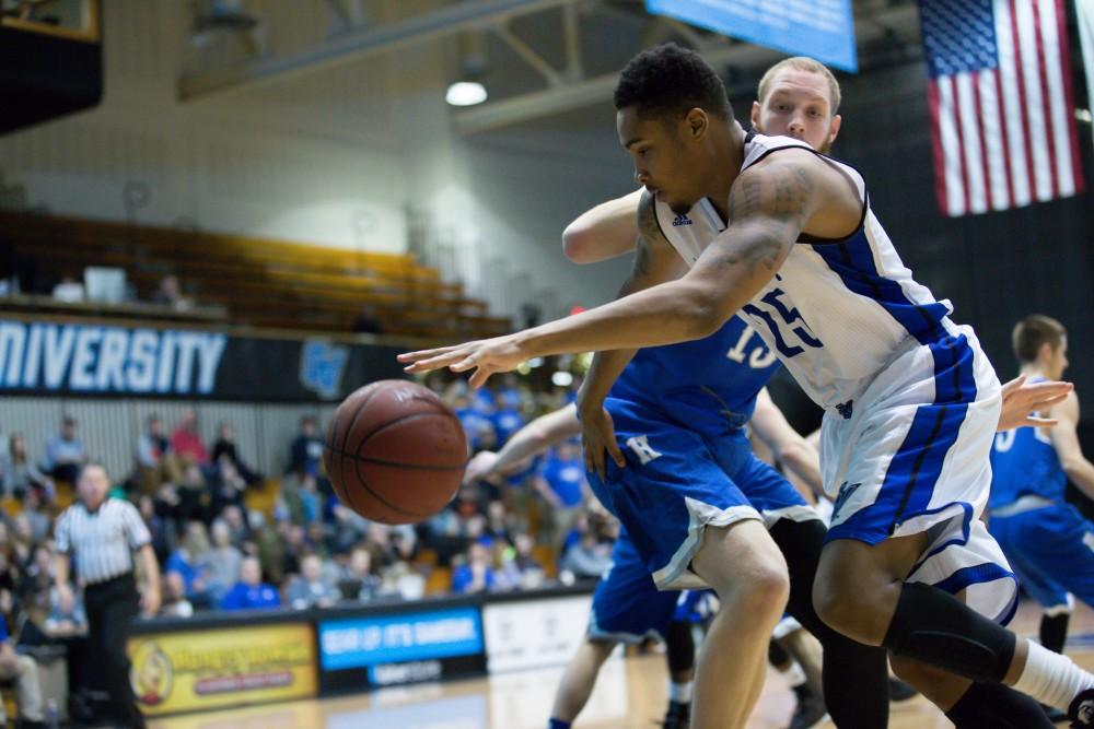 GVL / Kevin Sielaff - Chaz Rollins (25) dribbles the ball along the baseline.  The Lakers defeat the Chargers of Hillsdale College Saturday, Jan. 30, 2016 in Allendale.