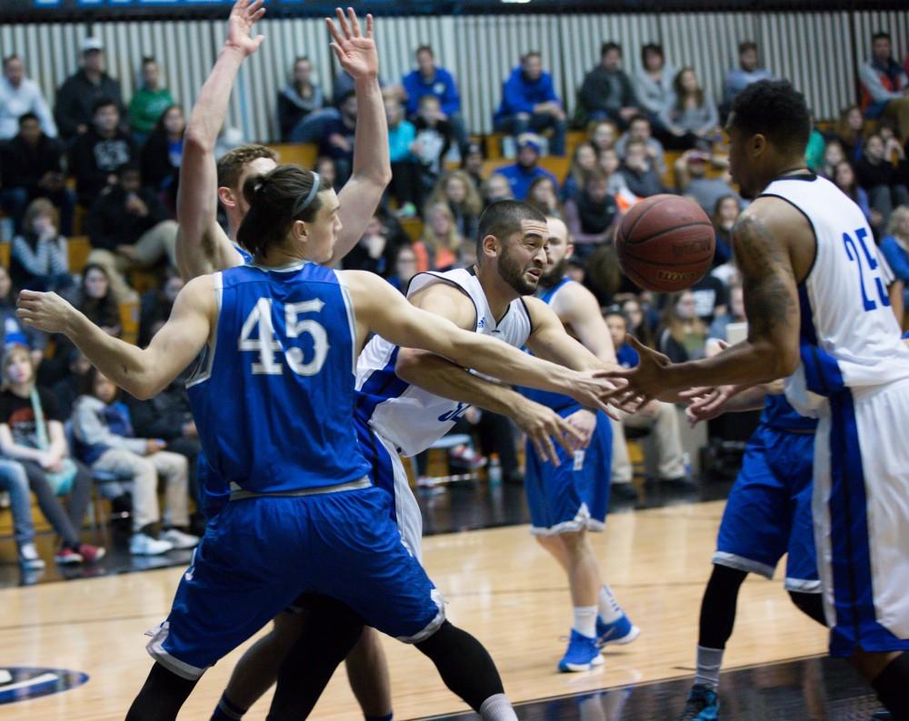 GVL / Kevin Sielaff - Ricardo Carbajal (32) loses his handle and the ball is picked up by Chaz Rollins (25).  The Lakers defeat the Chargers of Hillsdale College Saturday, Jan. 30, 2016 in Allendale.