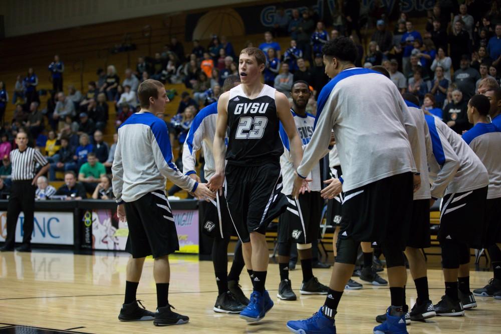 GVL / Kevin Sielaff - Luke Ryskamp (23) is greeted by his teammates before the match begins.  The Lakers defeat the Huskies of Michigan Tech with a final score of 64-53 Jan. 17, 2016 in Allendale.