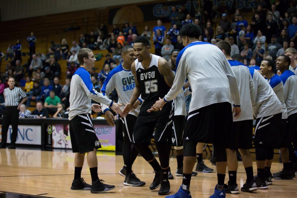 GVL / Kevin Sielaff - Chaz Rollins (25) is greeted by his teammates before the match begins.  The Lakers defeat the Huskies of Michigan Tech with a final score of 64-53 Jan. 17, 2016 in Allendale.