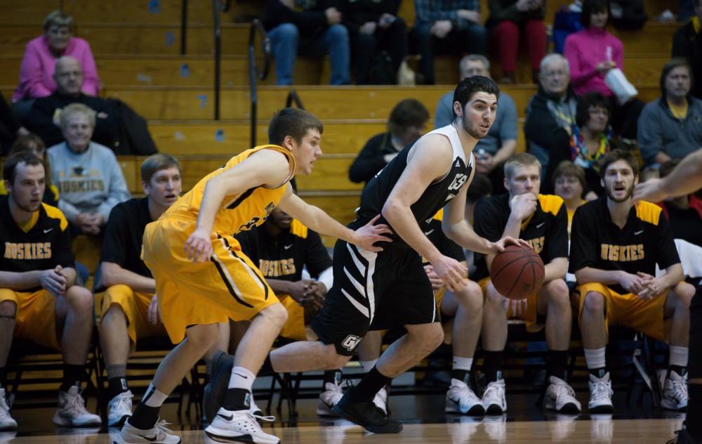 GVL / Kevin Sielaff - Zach West (11) dribbles around the perimeter and looks to pass the ball.  The Lakers defeat the Huskies of Michigan Tech with a final score of 64-53 Jan. 17, 2016 in Allendale.