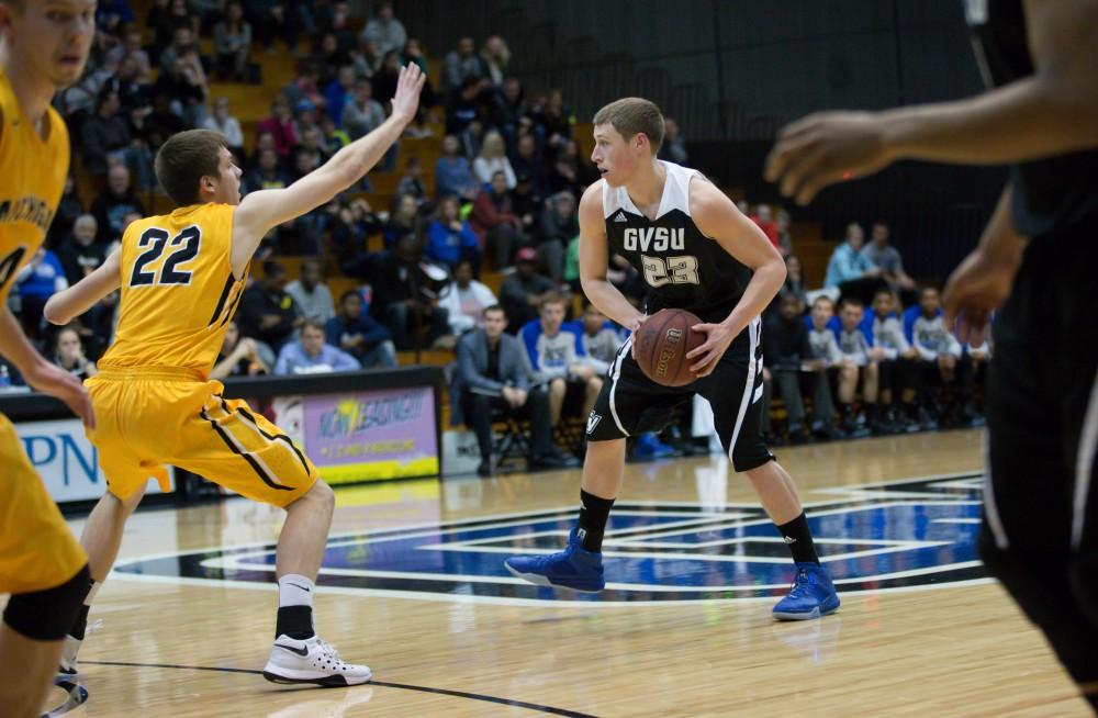 GVL / Kevin Sielaff - Luke Ryskamp (23) looks to pass the ball around the arch.  The Lakers defeat the Huskies of Michigan Tech with a final score of 64-53 Jan. 17, 2016 in Allendale.