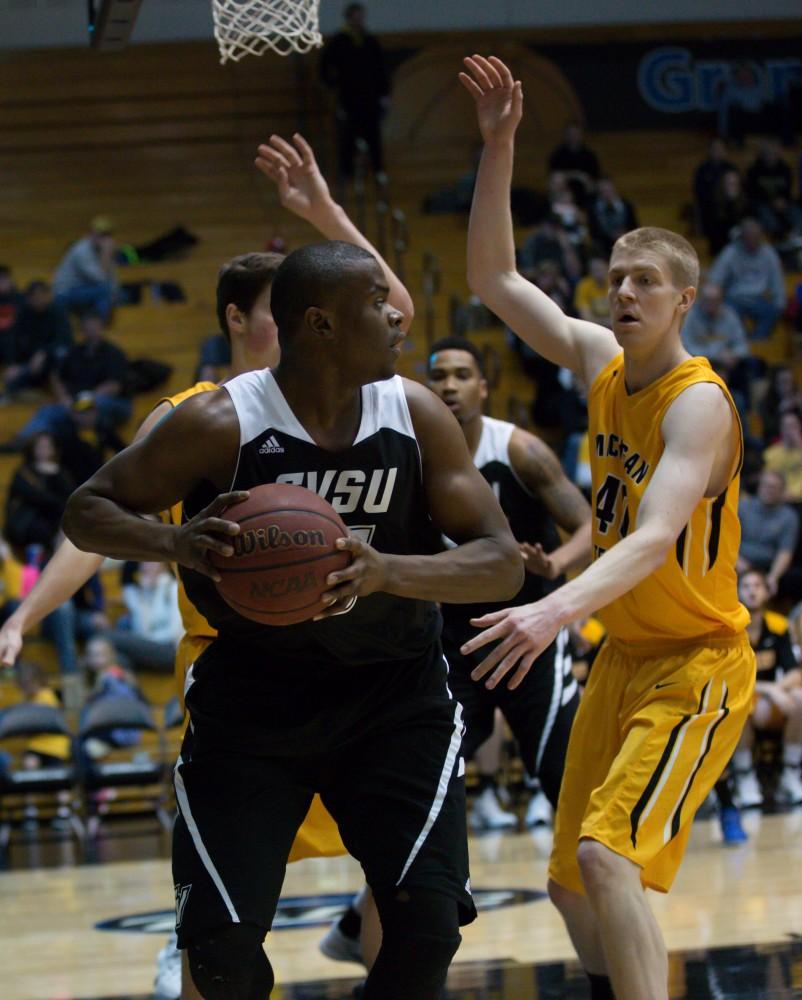 GVL / Kevin Sielaff - Trevin Alexander (5) backs up in the paint and looks to pass the ball.  The Lakers defeat the Huskies of Michigan Tech with a final score of 64-53 Jan. 17, 2016 in Allendale.