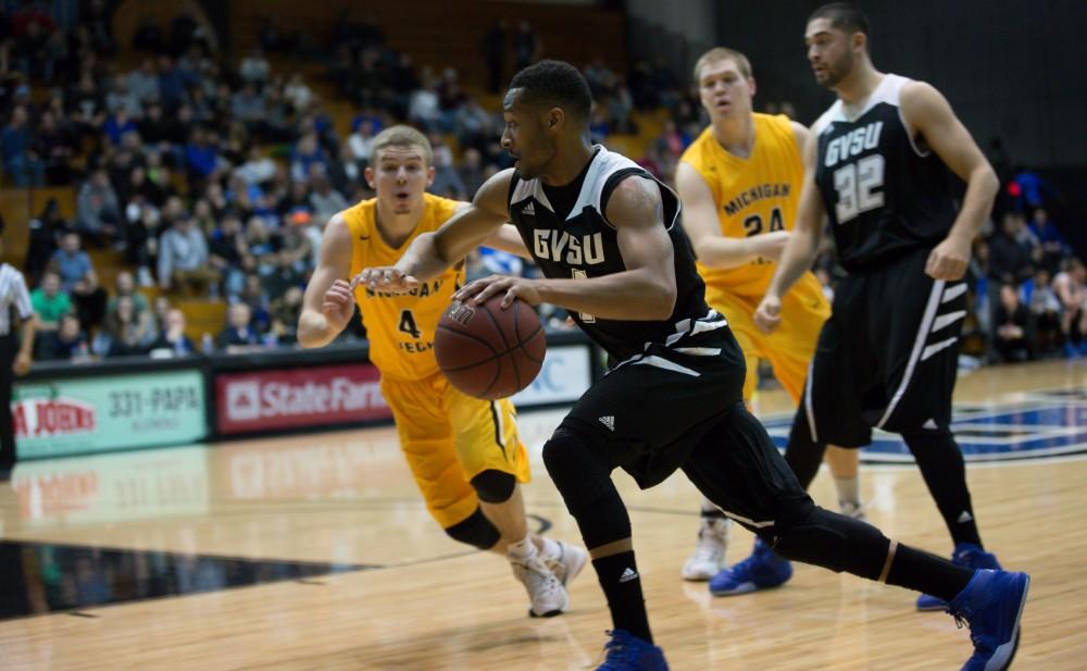 GVL / Kevin Sielaff - Aaron Hayes (1) drives hard toward the net as the Huskies follow chase.  The Lakers defeat the Huskies of Michigan Tech with a final score of 64-53 Jan. 17, 2016 in Allendale.