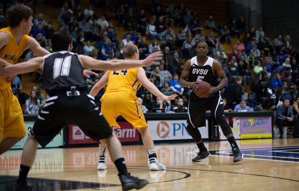 GVL / Kevin Sielaff - Trevin Alexander (5) looks to pass the ball to Zach West (11).  The Lakers defeat the Huskies of Michigan Tech with a final score of 64-53 Jan. 17, 2016 in Allendale.