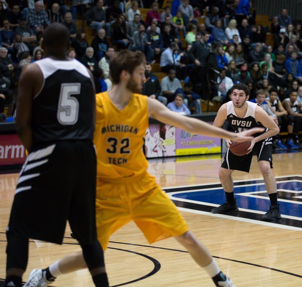 GVL / Kevin Sielaff - Zach West (11) looks to pass the ball into the paint and toward Trevin Alexander (5).  The Lakers defeat the Huskies of Michigan Tech with a final score of 64-53 Jan. 17, 2016 in Allendale.