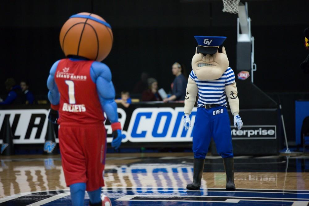 GVL / Kevin Sielaff - Louie the Laker squares off against the Grand Rapids Drive mascot during first intermission.  The Lakers defeat the Huskies of Michigan Tech with a final score of 64-53 Jan. 17, 2016 in Allendale.