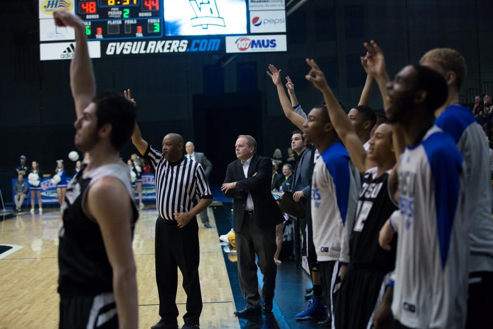 GVL / Kevin Sielaff - Zach West (11) fires a three as the Laker bench rises with him.  The Lakers defeat the Huskies of Michigan Tech with a final score of 64-53 Jan. 17, 2016 in Allendale.