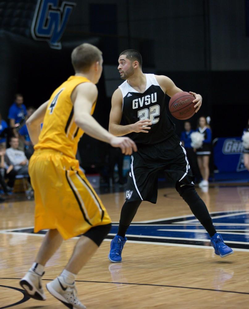 GVL / Kevin Sielaff - Ricardo Carbajal (32) possesses the ball at the top of the arch.  The Lakers defeat the Huskies of Michigan Tech with a final score of 64-53 Jan. 17, 2016 in Allendale.