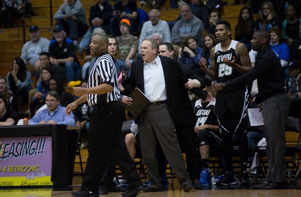 GVL / Kevin Sielaff - The Laker bench holds back head coach Ric Wesley as he makes his displeasure known to the officals.  The Lakers defeat the Huskies of Michigan Tech with a final score of 64-53 Jan. 17, 2016 in Allendale.