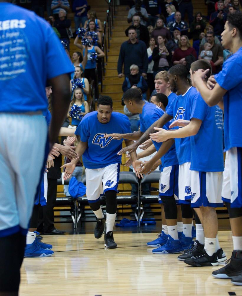 GVL / Kevin Sielaff - Chaz Rollins (25) runs onto the court before the start of the match.  The Lakers defeat the Timberwolves of Northwood University with a final score of 66-53 Jan. 24, 2016 in Allendale.