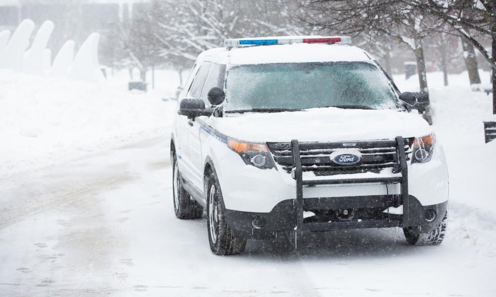 GVL / Kevin Sielaff -  A GVPD patrol vehicle is stationed outside of Zumberge before the start of the silent march. Touré, Vice columnist and well known author, visits Grand Valley's Allendale campus on a chilly Jan. 18, 2016. Hundreds of students gathered inside the Fieldhouse to listen to Touré's keynote speech; the students also participated in a silent march before the event.