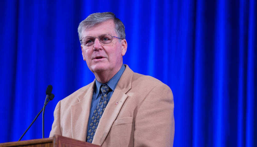 GVL / Kevin Sielaff - GVSU President Thomas Haas introduces the afternoon's keynote speaker Touré.  Touré, Vice columnist and well known author, visits Grand Valley's Allendale campus on a chilly Jan. 18, 2016. Hundreds of students gathered inside the Fieldhouse to listen to Touré's keynote speech; the students also participated in a silent march before the event.