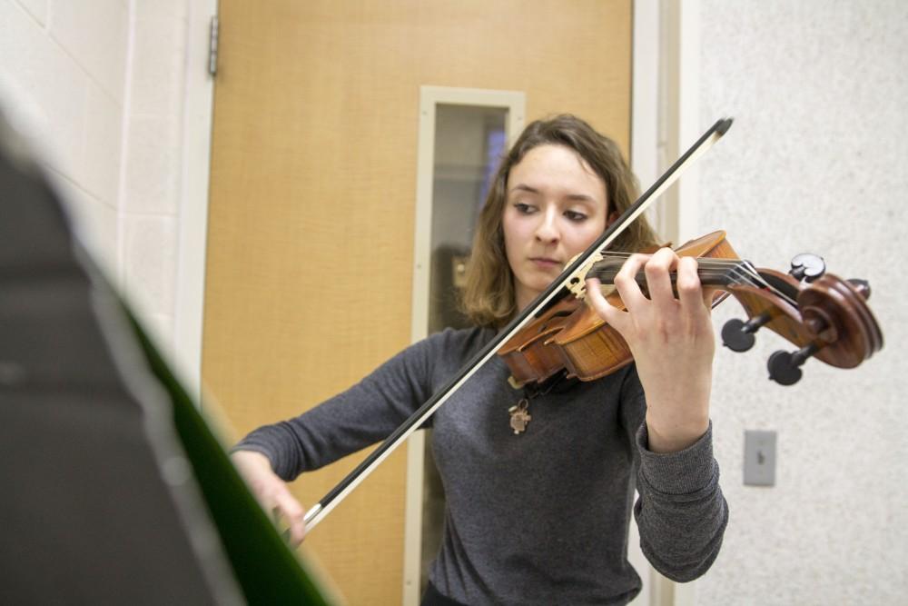 GVL / Sara Carte
Music Eduaction major, Ashley Qooistra, practices playing her violin in a practice room in the Performing Arts Center on Friday, Jan. 29, 2016.