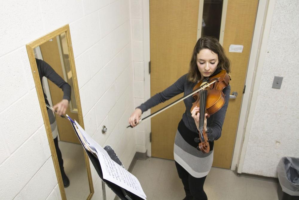 GVL / Sara Carte
Music Eduaction major, Ashley Qooistra, practices playing her violin in a practice room in the Performing Arts Center on Friday, Jan. 29, 2016.