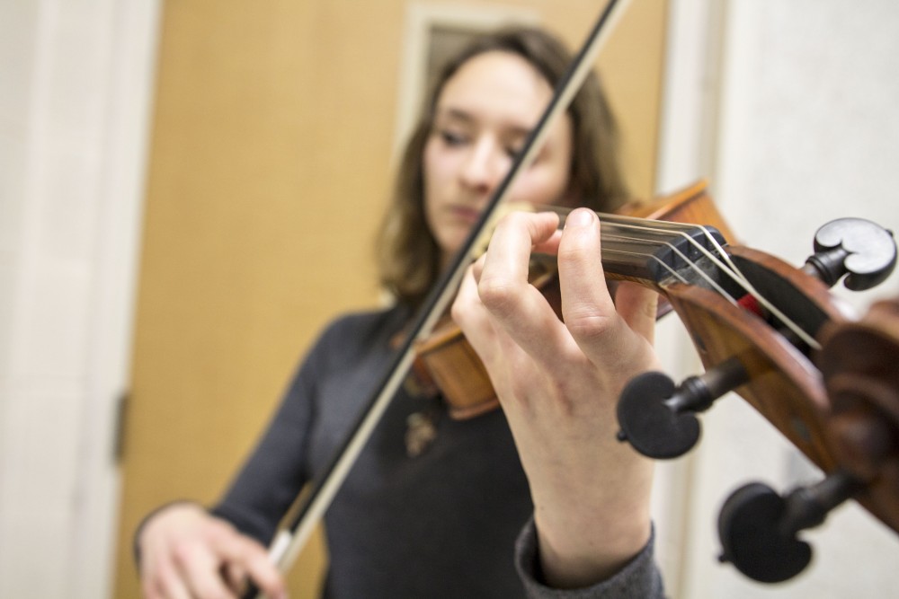 GVL / Sara Carte
Music Eduaction major, Ashley Qooistra, practices playing her violin in a practice room in the Performing Arts Center on Friday, Jan. 29, 2016.