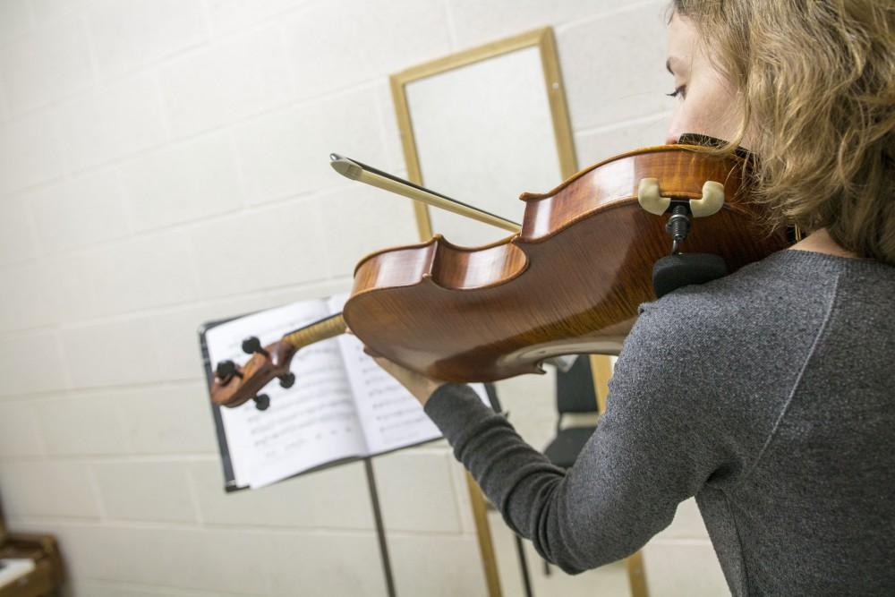 GVL / Sara Carte
Music Eduaction major, Ashley Qooistra, practices playing her violin in a practice room in the Performing Arts Center on Friday, Jan. 29, 2016.