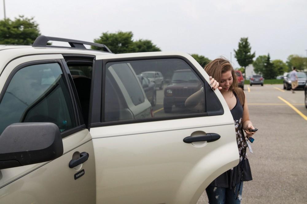 GVL / Sara Carte
Grand Valley Student, Bethany Garcia, grabs her bags from her car on her way to class on Tuesday, Septmeber 8, 2015.