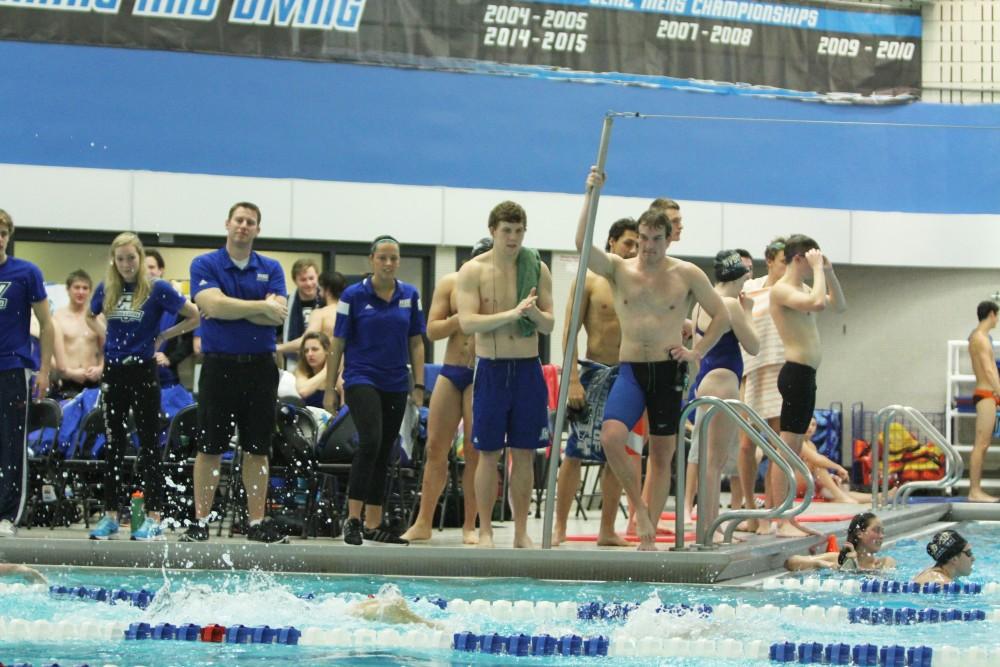 Members of the Swim and Dive team cheer on their teammates during the swimmeat against Findlay on Jan 23 in Allendale, MI. 