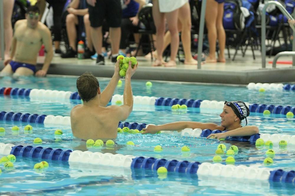 Members of both the Grand Valley and Findlay Swim and Dive teams helped collect all of the tennis balls thrown into the pool by the crowd on Jan 23 in Allendale, MI. 