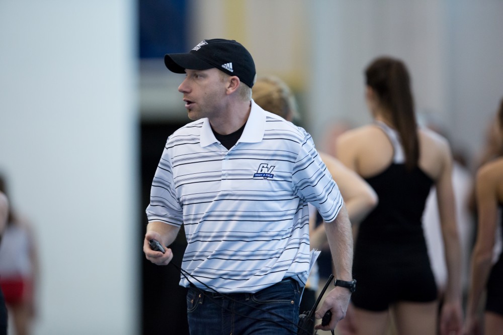 GVL / Kevin Sielaff - Head coach Jerry Baltes leads the mile runners to their starting lines.  The Kelly Family Sports Center hosts the Bob Eubanks Open Jan. 15, 2016.