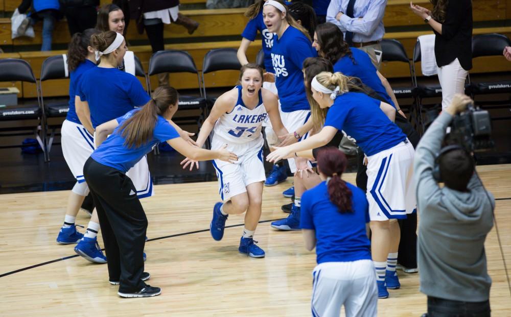 GVL / Kevin Sielaff - Bailey Cairnduff (34) charges onto the court before the match.  The Lakers defeat the Chargers of Hillsdale College Saturday, Jan. 30, 2016 in Allendale.