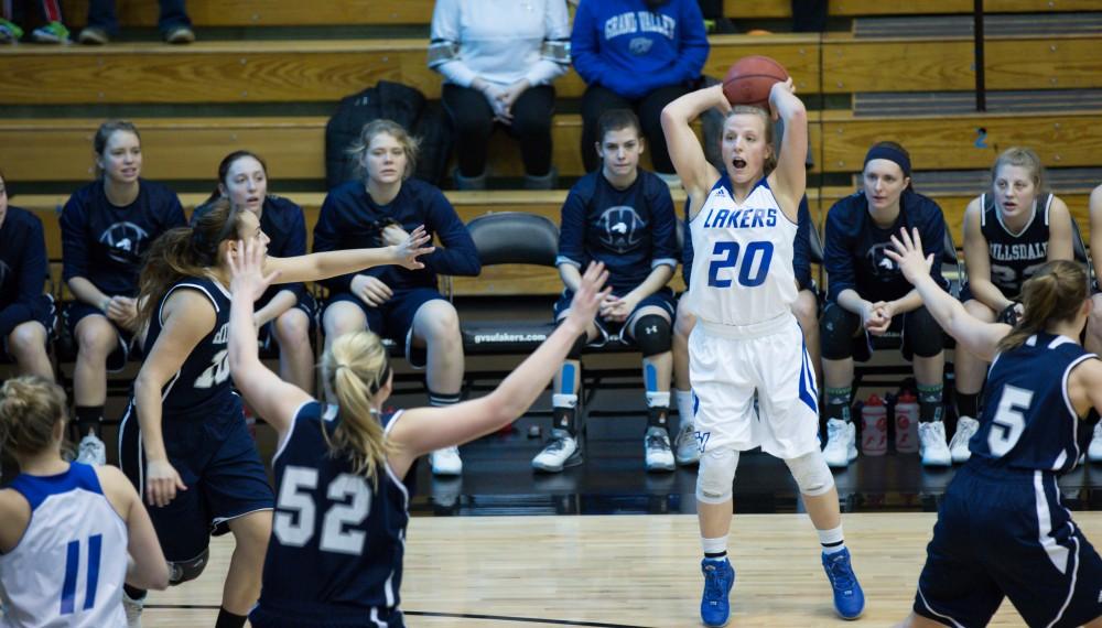 GVL / Kevin Sielaff - Janae Langs (20), swarmed by the Charger defense, looks to pass the ball.  The Lakers defeat the Chargers of Hillsdale College Saturday, Jan. 30, 2016 in Allendale.