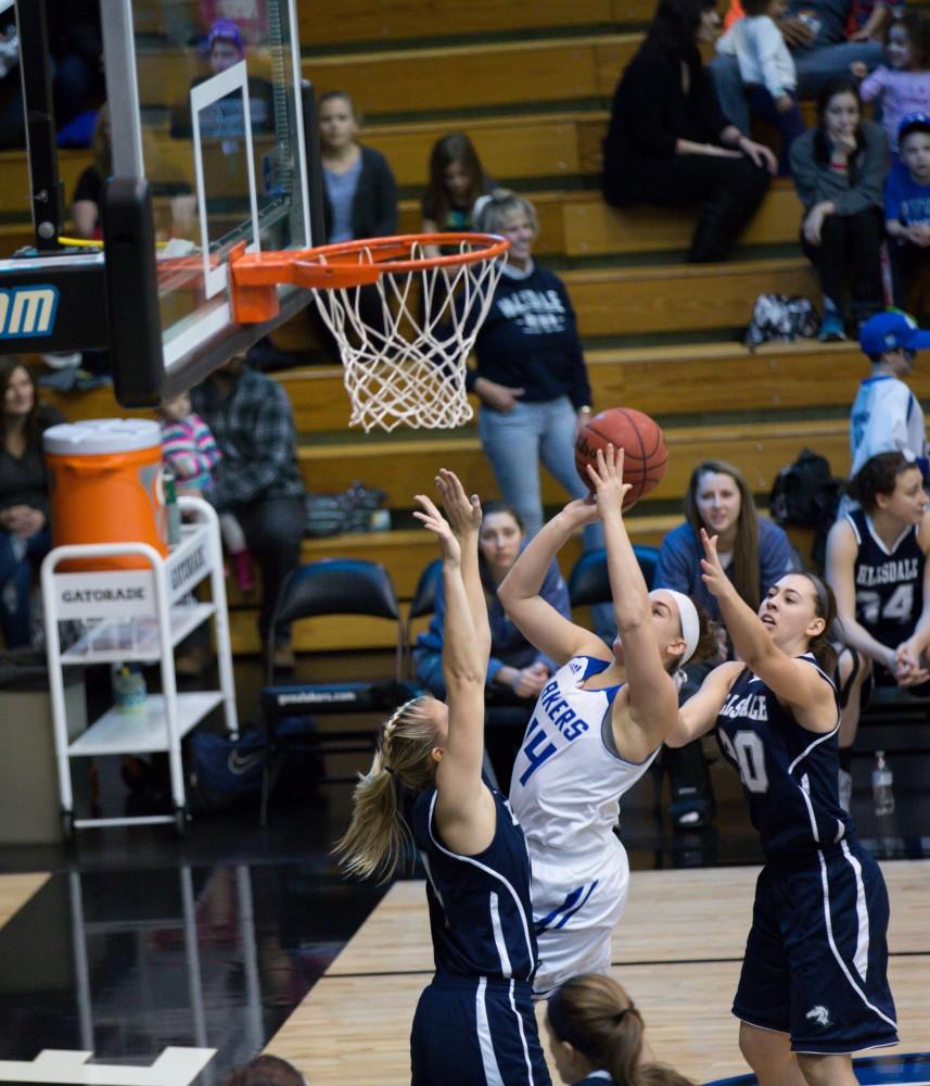 GVL / Kevin Sielaff - Taylor Parmley (14) drives to the hoop for a layup. The Lakers defeat the Chargers of Hillsdale College Saturday, Jan. 30, 2016 in Allendale.