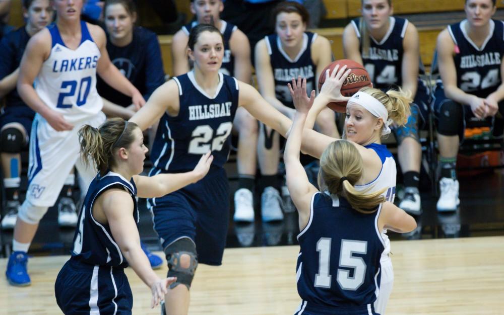 GVL / Kevin Sielaff - Lindsay Baker (15) gets tied up and looks to pass the ball.  The Lakers defeat the Chargers of Hillsdale College Saturday, Jan. 30, 2016 in Allendale.