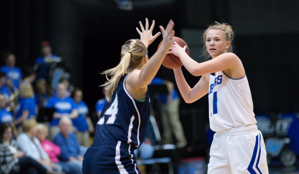 GVL / Kevin Sielaff - Piper Tucker (11) passes the ball around the arch.  The Lakers defeat the Chargers of Hillsdale College Saturday, Jan. 30, 2016 in Allendale.