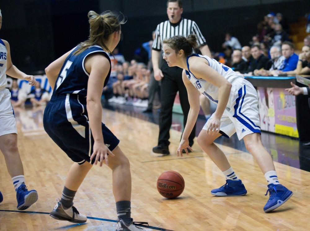 GVL / Kevin Sielaff - Bailey Cairnduff (34) dribbles the ball around the three point line.  The Lakers defeat the Chargers of Hillsdale College Saturday, Jan. 30, 2016 in Allendale.