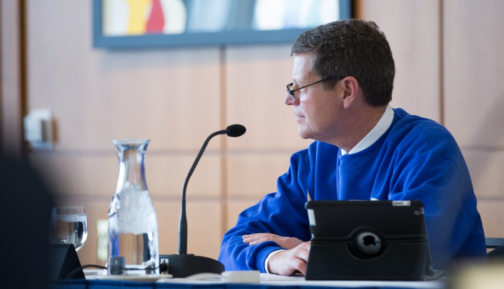 GVL / Kevin Sielaff - David Hooker listens to a fellow trustee at the Board of Trustees meeting on Friday, Feb. 12, 2016 in the Seidman College of Business on Grand Valley's Pew Campus.