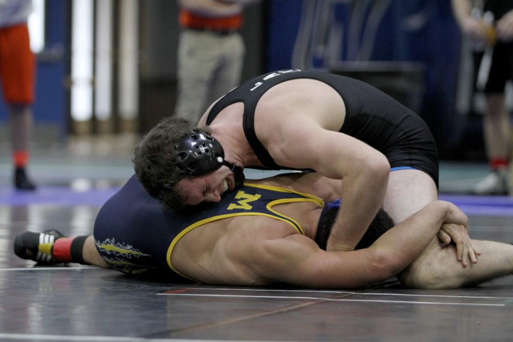 Eric Dietz works to keep his opponent on the ground to win the club wrestling match on Feb. 6 in Allendale, MI. 