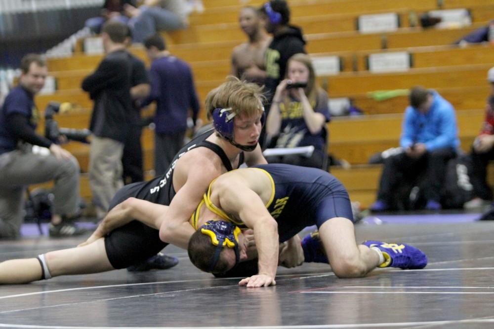 Brennan Hazelton holds down his opponent from the University of Michigan on Feb. 6 in Allendale, MI. 