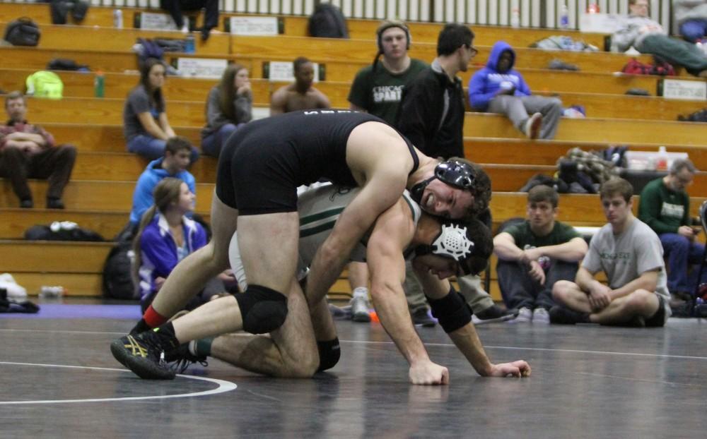 Eric Dietz works to hold down his opponent during the club wrestling match on Feb. 6 in Allendale, MI. 