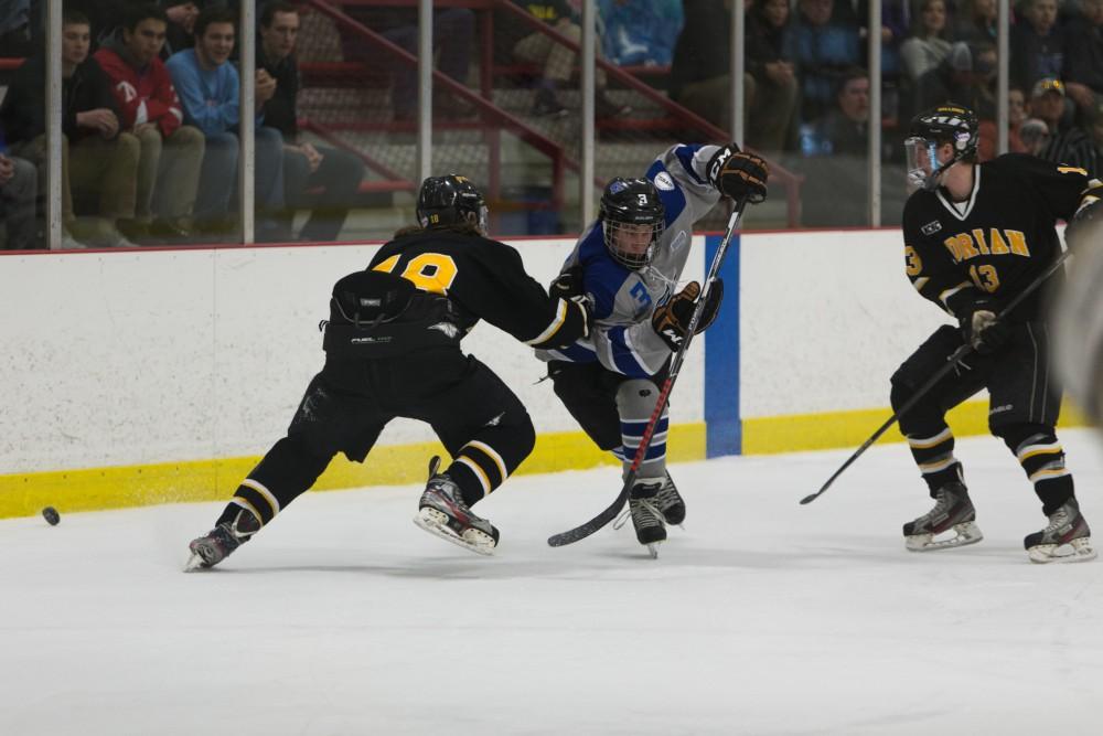 GVL/Luke Holmes
Danny Smith (3) battles to get around his defender to reach the puck. Grand Valley D3 Mens Hockey had a victory over Adrian College Saturday, Jan. 30, 2015.