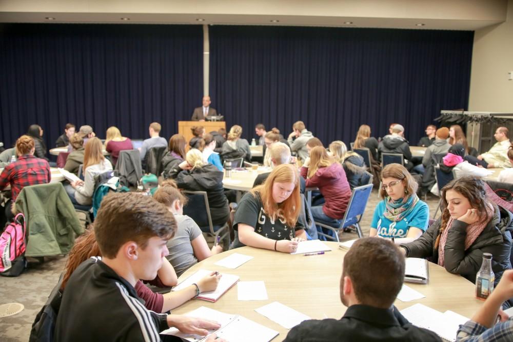 GVL / Sara Carte - Grand Valley students listen and takes notes while Georgetown University professor, Dr. Harb, speaks about the current events happening in Iraq and Syria in the Mary Idema Pew Library Multi-Purpose room on Thursday, Feb. 18, 2016.