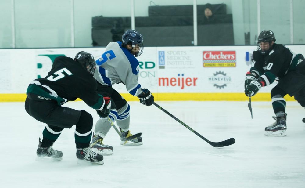 GVL / Kevin Sielaff - John Nagel (5) skates the puck into MSU's zone.  The Lakers’ D3 men’s hockey team blows out Michigan State at Eagle Ice Center in Grand Rapids on Friday, February 12, 2016.