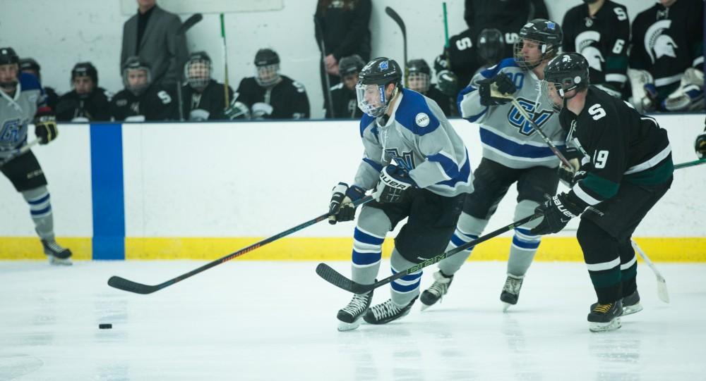 GVL / Kevin Sielaff - Blaine Marney (19) moves the puck in MSU's zone.  The Lakers’ D3 men’s hockey team blows out Michigan State at Eagle Ice Center in Grand Rapids on Friday, February 12, 2016.