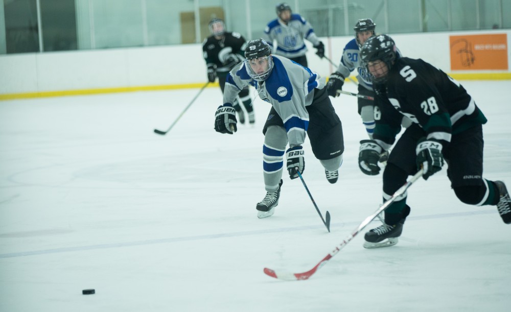 GVL / Kevin Sielaff - Blaine Marney (19) chases the puck in MSU's zone.  The Lakers’ D3 men’s hockey team blows out Michigan State at Eagle Ice Center in Grand Rapids on Friday, February 12, 2016.