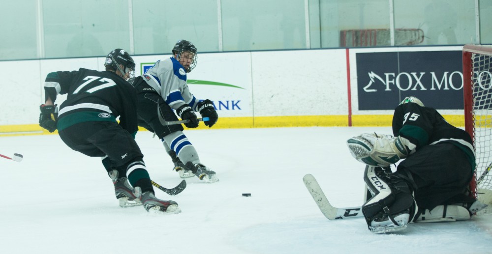 GVL / Kevin Sielaff - Tyler Stoller (17) tries a backhanded shot on net.  The Lakers’ D3 men’s hockey team blows out Michigan State at Eagle Ice Center in Grand Rapids on Friday, February 12, 2016.