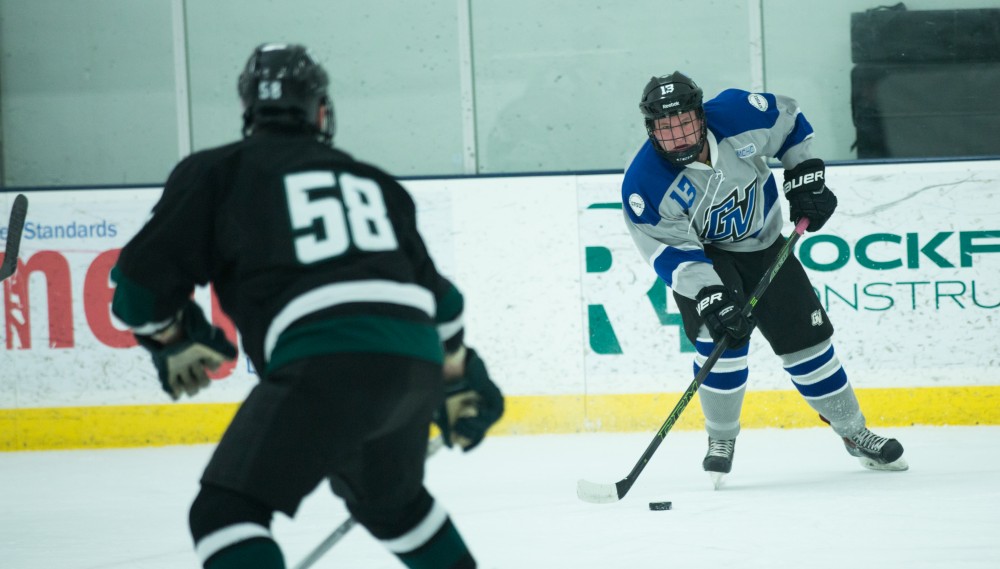 GVL / Kevin Sielaff - Zach Nash (13) looks to pass the puck in front of MSU's net.  The Lakers’ D3 men’s hockey team blows out Michigan State at Eagle Ice Center in Grand Rapids on Friday, February 12, 2016.