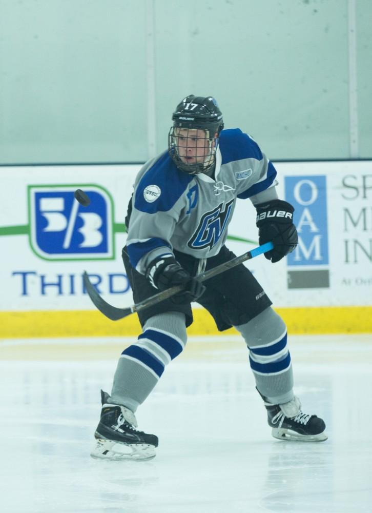 GVL / Kevin Sielaff - Tyler Stoller (17) juggles the puck in mid air before bringing it back down to the ice.  The Lakers’ D3 men’s hockey team blows out Michigan State at Eagle Ice Center in Grand Rapids on Friday, February 12, 2016.