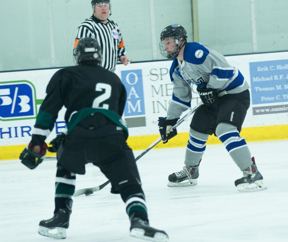 GVL / Kevin Sielaff - Eric White (18) lines up a shot on MSU's net.  The Lakers’ D3 men’s hockey team blows out Michigan State at Eagle Ice Center in Grand Rapids on Friday, February 12, 2016.