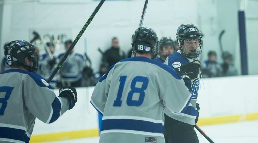 GVL / Kevin Sielaff - Nick Pratt (15) celebrates a goal with his teammates.  The Lakers’ D3 men’s hockey team blows out Michigan State at Eagle Ice Center in Grand Rapids on Friday, February 12, 2016.