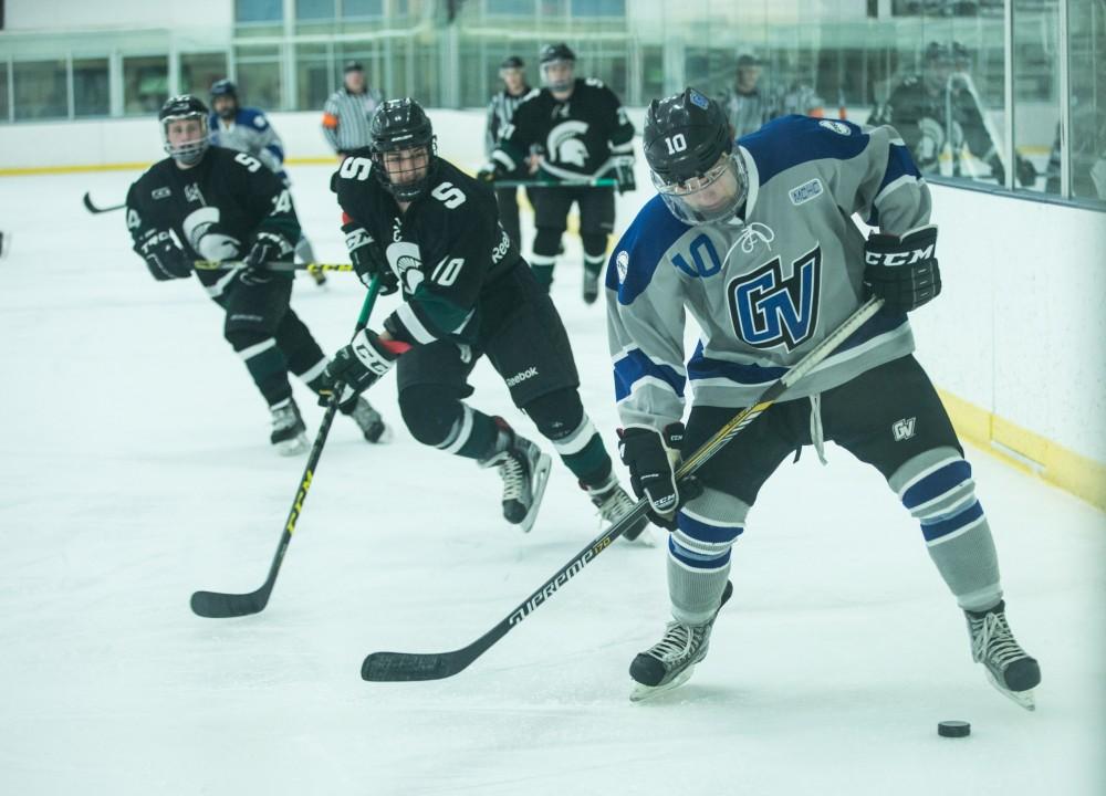 GVL / Kevin Sielaff - Ethan Doyle (15) kicks the puck to his stick as it rattles off the boards.  The Lakers’ D3 men’s hockey team blows out Michigan State at Eagle Ice Center in Grand Rapids on Friday, February 12, 2016.