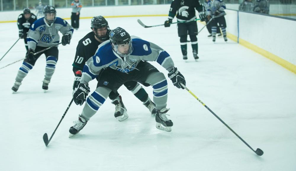 GVL / Kevin Sielaff - Corey Smith (27), losing his handle on the puck, skates toward the boards. The Lakers’ D3 men’s hockey team blows out Michigan State at Eagle Ice Center in Grand Rapids on Friday, February 12, 2016.